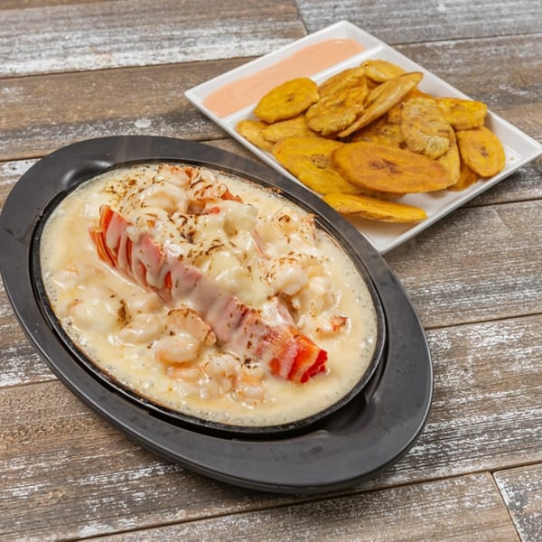 Sizzling Caribbean lobster and shrimp in creamy sauce, served with fried plantains and dipping sauce.